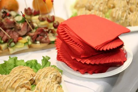 Set of red tissues among the snacks at the stand-up party or buffet lunch Stock Photos