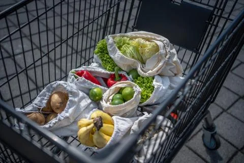 Set of reusable and zero waste cotton shopping bags for food in cart Stock Photos