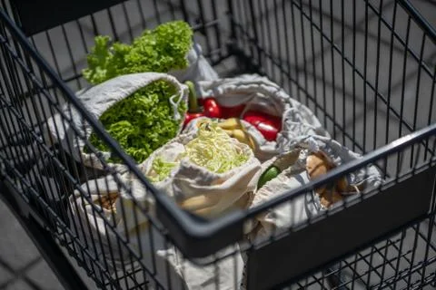 Set of reusable and zero waste cotton shopping bags for food in cart Stock Photos