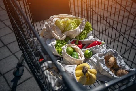 Set of reusable and zero waste cotton shopping bags for food in cart Stock Photos