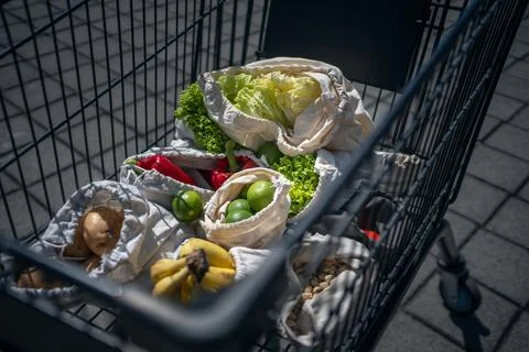 Set of reusable and zero waste cotton shopping bags for food in cart Stock Photos