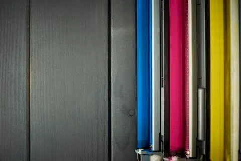 Set of rollers in color laser printer ink cartridges on wooden background Stock Photos