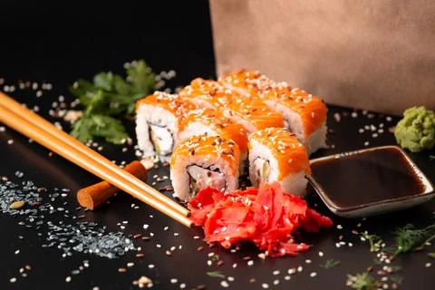 Set of rolls on a dark background with Chinese chopsticks Stock Photos