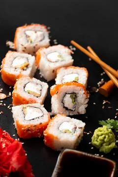Set of rolls on a dark background with Chinese chopsticks Stock Photos