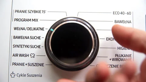 Set the round programmer on the washing machine to the program - wash and dry. Video stock 231768782