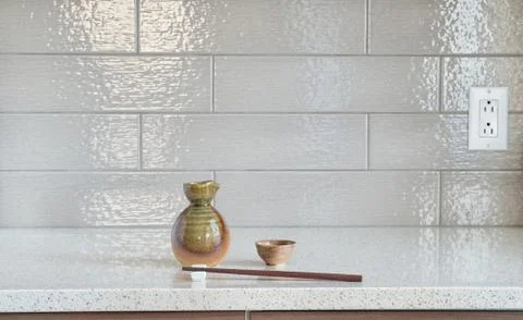 Set of sake cup and container with wooden chopsticks on granite countertop 스톡 사진