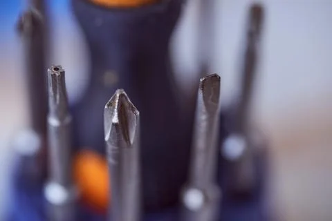 Set of screwdrivers on blue blurred background. Close-up. Stock Photos