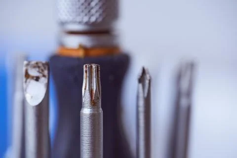 Set of screwdrivers on blue blurred background. Close-up. Stock Photos