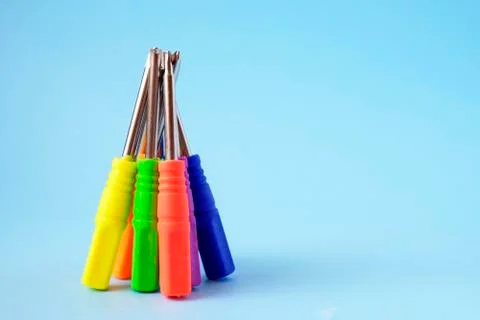 Set of screwdrivers with multi-colored handles on blue background. Fotos de archivo