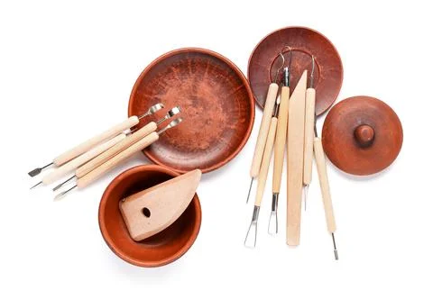 Set of sculptor tools and ceramic plates isolated on white background Stock Photos