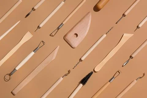 Set of sculptor tools on beige background Stock Photos