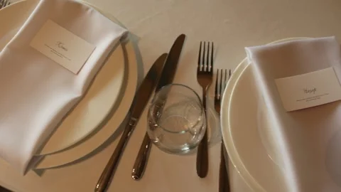 Set of serving dishes on the table in a restaurant plate fork knife Stock Footage 305313835