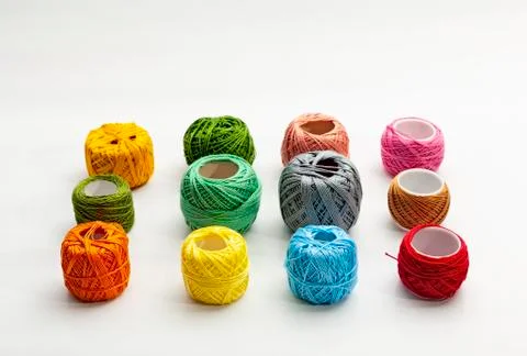 Set of several spools of thread of different colors on a white background. Stock Photos
