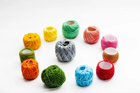 Set of several spools of thread of different colors on a white background. Stock Photos