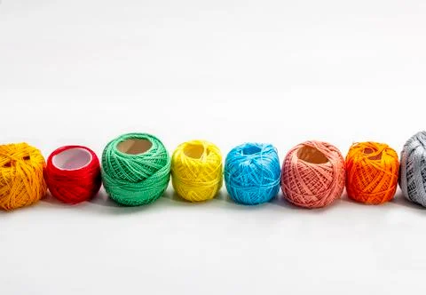 Set of several spools of thread of different colors on a white background. Stock Photos