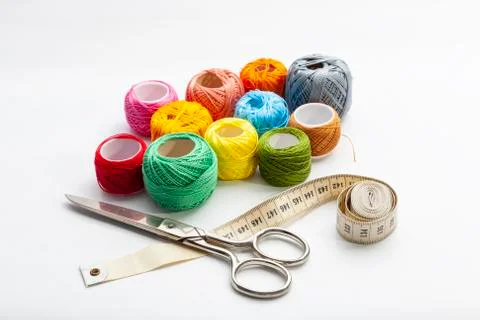 Set of several spools of thread of different colors, a pair of scissors and a Stock Photos