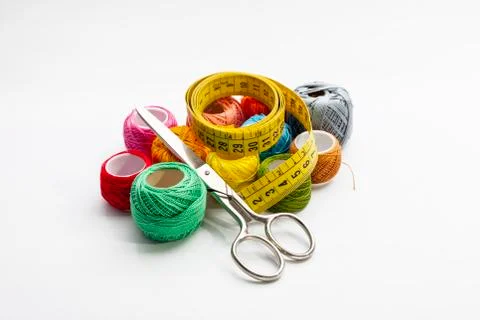 Set of several spools of thread of different colors, a pair of scissors and a Stock Photos