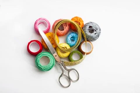 Set of several spools of thread of different colors, a pair of scissors and a Stock Photos