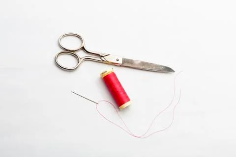 Set of several spools of thread of different colors, a pair of scissors and a Stock Photos