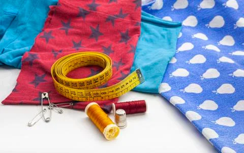 Set of several spools of thread, scissors, a tailor's tape, several safety pins Stock Photos