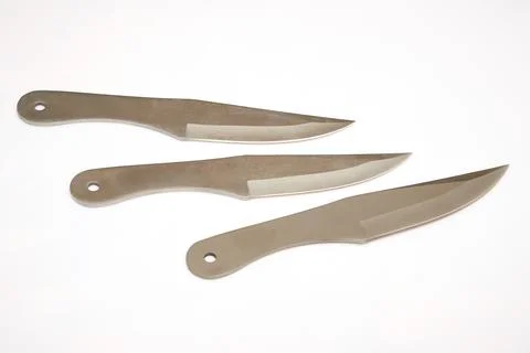 Set of several throwing knives isolated on white background Stock Photos