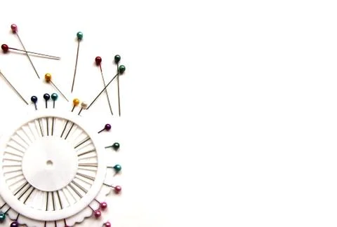 Set of sewing pins with colored beads in an white organizer on a white bg. Stock Photos