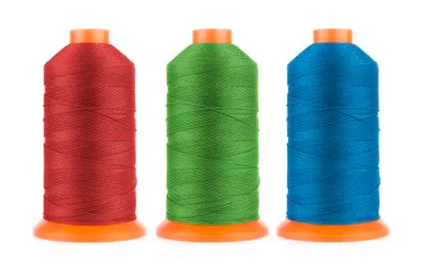 Set of sewing threads in red, blue and green colors isolated on white background Photos