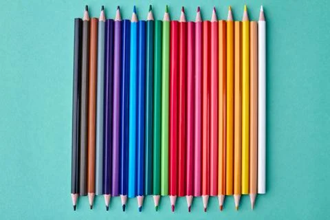 Set of sharp crayons on color background. Stock Photos