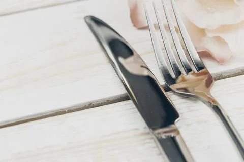 Set of silverware on white wooden table close up Stock Photos