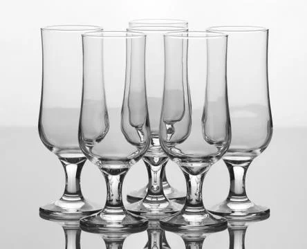 Set of six elegant empty glasses isolated on white background Stock Photos