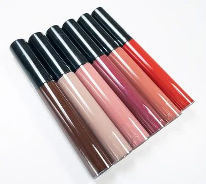 A set of six lipsticks in different red, beige, brown, peach, pink, plum shad Stock Photos