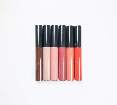 A set of six lipsticks in different red, beige, brown, peach, pink, plum shad Stock Photos