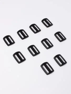 Set of small black slide buckles Stock Photos