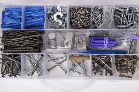 A set with small construction items in a box. Tool box with nails, screws, bo Stock Photos