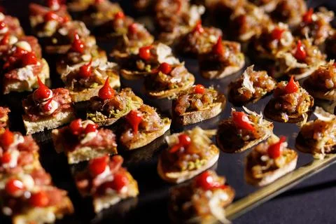 A set of small different snacks. Bite-sized catering canapes. Stock Photos