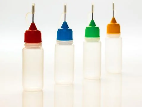 Set of small plastic sample bottles for liquids Stock Photos