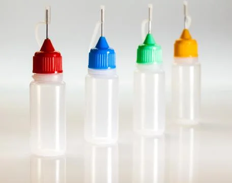 Set of small plastic sample bottles for liquids Stock Photos
