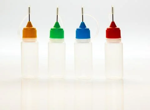 Set of small plastic sample bottles for liquids Stock Photos