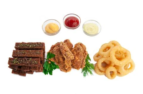 A set of snacks for beer. Consisting of rye croutons, squid rings and breaded Stock Photos