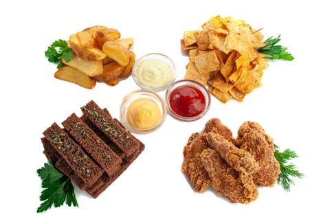 A set of snacks for beer. Consisting of rye croutons, baked potatoes, corn ch Stock Photos