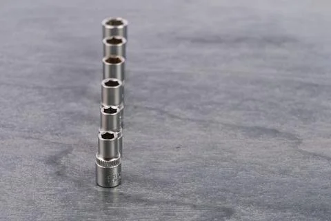 Set of socket wrench extensions on gray surface Stock Photos