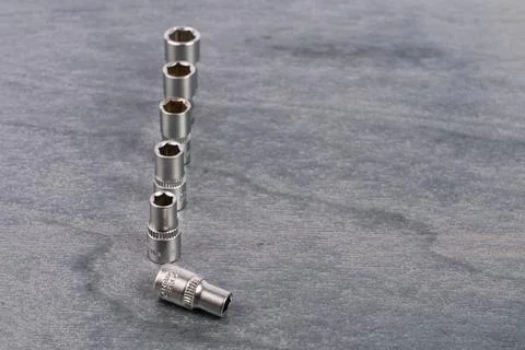 Set of socket wrench extensions on gray surface Stock Photos