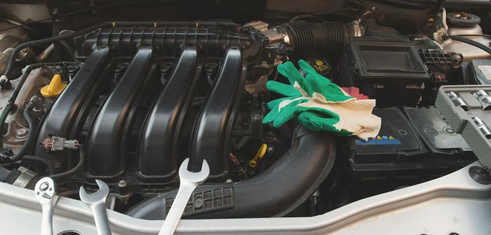 A set of socket wrenches lies on the internal combustion engine of a car in t 写真素材
