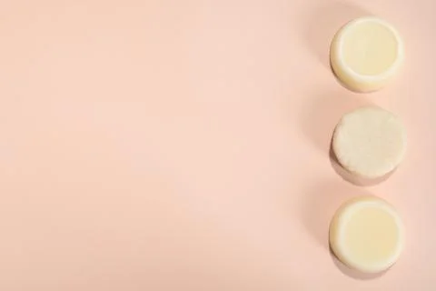 Set of solid shampoo bars on pink background, flat lay. Space for text 写真素材