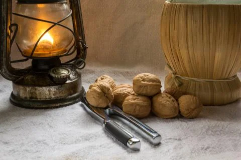 Set with some walnuts, a nutcracker and a lantern Stock Photos