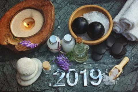 Set for spa procedures in 2019, bath salt and massage oil along with candles  Stock Photos
