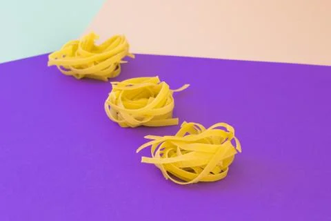 Set of spaghetti on violet background Stock Photos