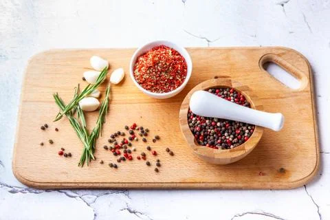Set of spice chopping on a wooden board: rosemary, garlic, pepper, paprika Stock Photos