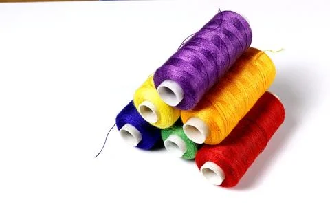 A set of spools of colored sewing threads. Stock Photos