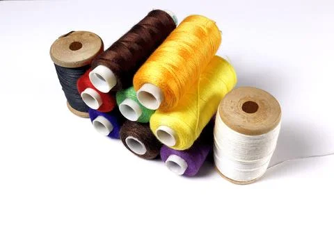 A set of spools of colored sewing threads. Stock Photos